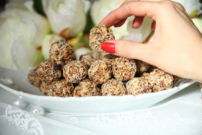 Close-up of hand holding food in bowl