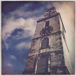 Low angle view of tower against cloudy sky