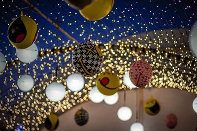 Low angle view of illuminated lights hanging from ceiling