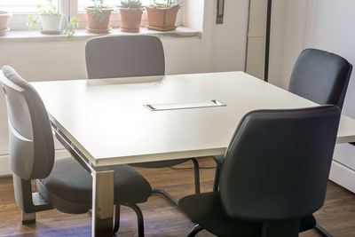 Empty chairs and table in office