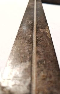 Close-up of rusty metal on table