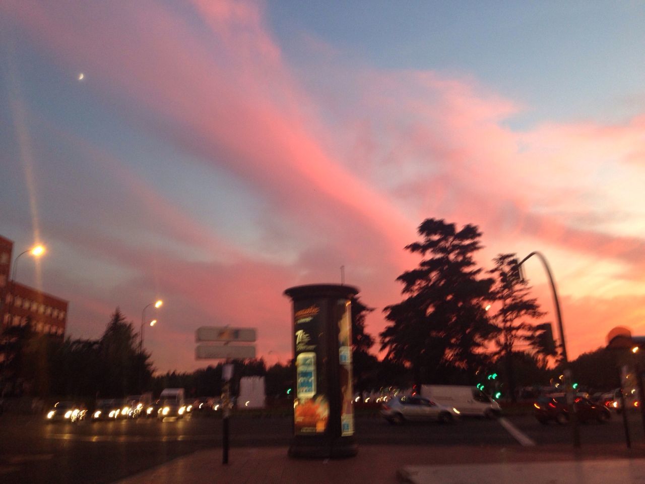 illuminated, sky, building exterior, architecture, built structure, street light, tree, city, cloud - sky, street, lighting equipment, night, car, sunset, dusk, road, transportation, outdoors, low angle view, land vehicle