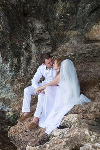 Woman sitting on rock