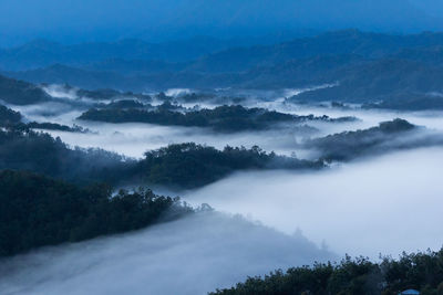 High angle view of trees and mountains against sky