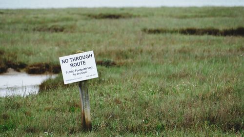 Information sign on grassy field