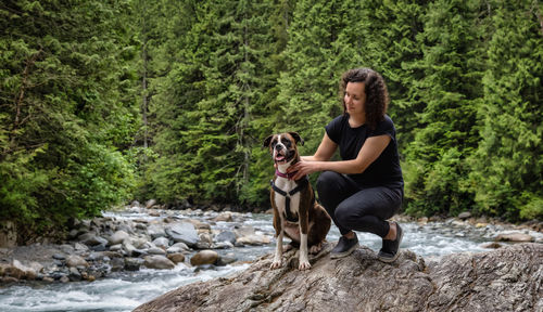 Full length of a dog on rock