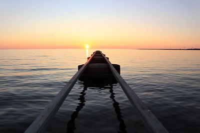 Silhouette pier on sea against sky during sunset