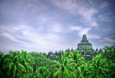 Panoramic view of trees and building against sky
