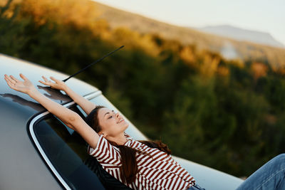 Low section of woman sitting in car