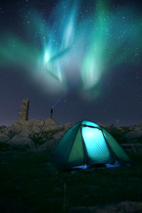 Illuminated tent against sky at night