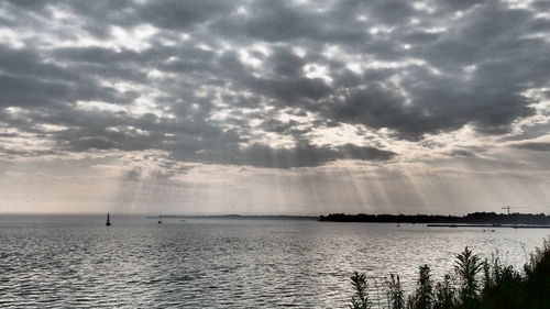 Scenic view of sea against cloudy sky