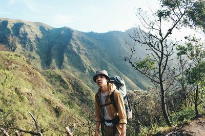 Rear view of man standing on mountain