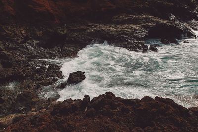 Scenic view of rock formation in sea against sky