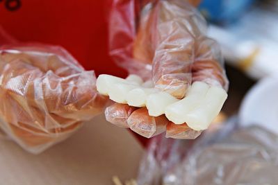 Close-up of hand holding ice cream on table