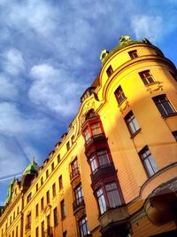 Low angle view of building against cloudy sky