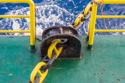 Close-up of chain tied on boat by sea