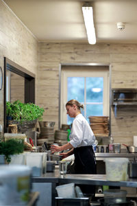 Side view of a man working in kitchen