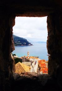 View of built structure by sea