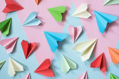 High angle view of multi colored paper airplane on table