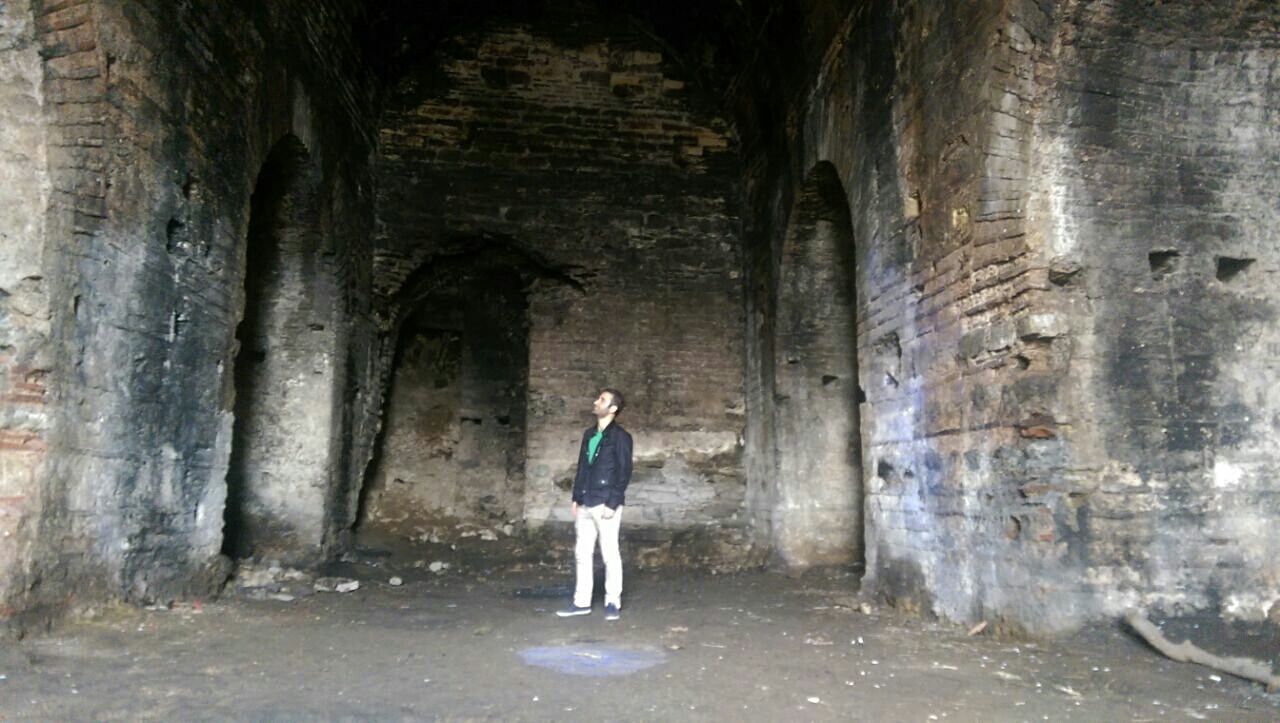 WOMAN STANDING IN CORRIDOR OF A BUILDING