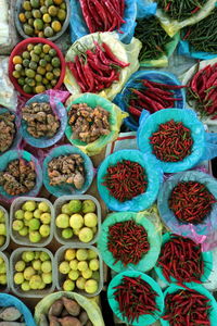 Directly above shot of chili peppers and lemon with gingers for sale