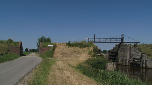 Empty road along built structures