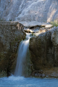 View of waterfall along rocks