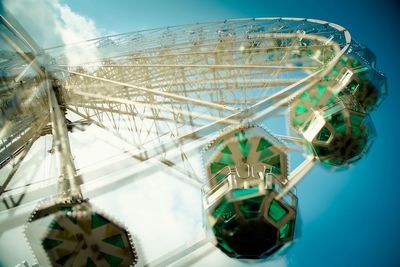 Low angle view of ferris wheel against blue sky