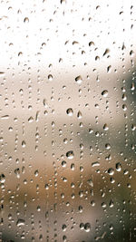 Full frame shot of raindrops on glass window