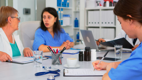 Female friends working at table