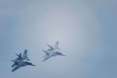 Low angle view of airplane flying in sky