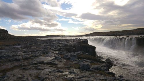 Scenic view of landscape against cloudy sky