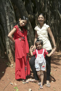 Full length portrait of happy girl standing outdoors