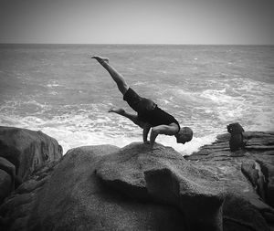Man on shore at beach against sky