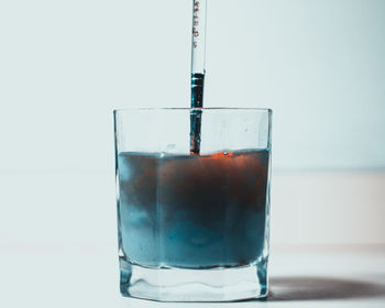 Close-up of wine glass against white background