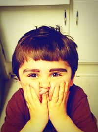 Close-up portrait of smiling boy at home