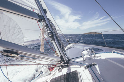 Sailboat sailing in sea against sky