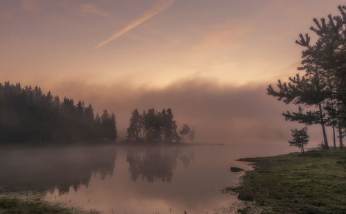 Scenic view of lake against sky during sunset