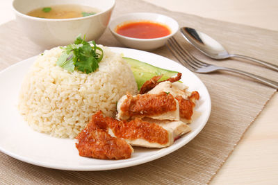 Close-up of roasted chicken rice in plate on table