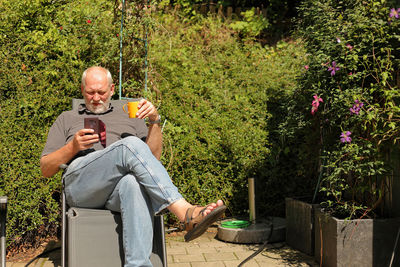 Low angle view of man sitting on tree