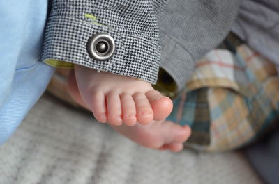 Low section of baby on bed