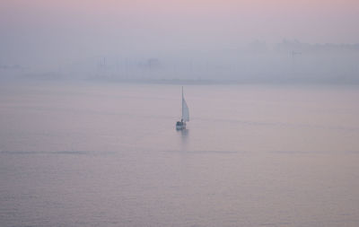 Sailboat in sea against sky during winter