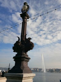 Low angle view of statue against cloudy sky