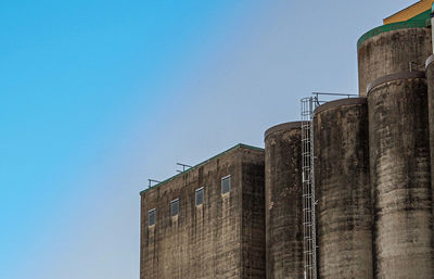 Low angle view of building against clear blue sky