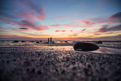 Scenic view of beach against sky during sunset