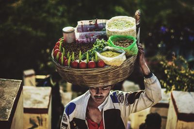 Portrait of man holding fruits