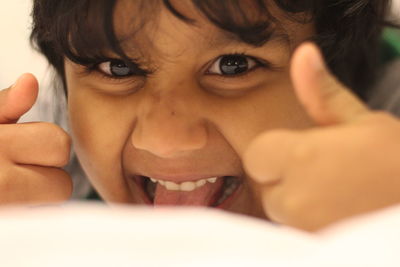 Close-up portrait of playful girl making face