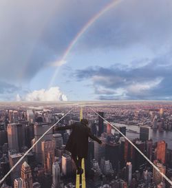 Panoramic view of rainbow over city buildings