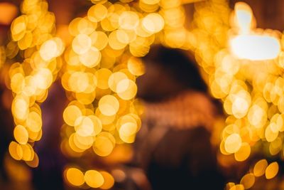 Defocused image of illuminated christmas lights at night