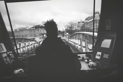 Rear view of woman driving train